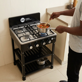 Face-hidden cooking scene with the H&A four-burner floor-standing gas stove