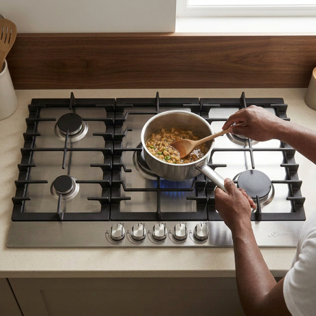 Face-hidden cooking scene with the Kaiser Grand Chef stainless-steel gas hob