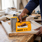 Face-hidden upholstery work using the Ingco HSG1408 staple gun on a fabric-covered wooden frame
