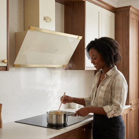 Home cook beneath the ivory Art Deco cooker hood