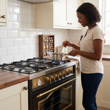 Home cook using the black-and-brass Kaiser Empire range