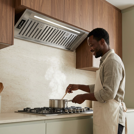 Home cook using the Kaiser stainless steel cooker hood
