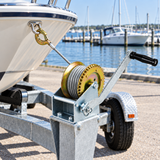 Manual cable winch mounted on a boat trailer