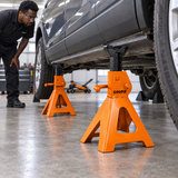 Mechanic checking Coofix jack stands beneath a vehicle support rail