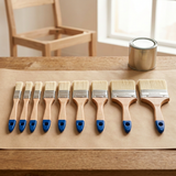 Nine Wadfow wooden-handled brushes arranged on a workshop bench
