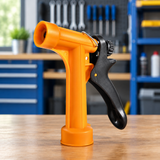 Orange trigger spray nozzle on a workshop table