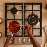 Overhead sauce-making scene with the Kaiser three-burner hob