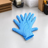 Pair of blue disposable gloves on a workbench