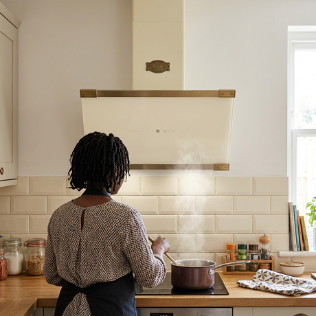 Rear-view cooking scene beneath the ivory Art Deco hood
