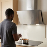 Rear-view cooking scene beneath the Kaiser stainless steel hood