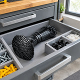 Bundled black nylon cable ties stored in an organised maintenance-room parts drawer.