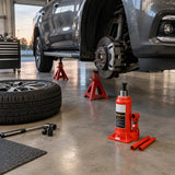 Vehicle safely supported on axle stands after an Atlas hydraulic bottle jack lifting task in a professional workshop.