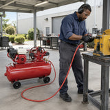 African American maintenance technician using a pneumatic impact wrench supplied by a Mirage gasoline air compressor at an outdoor service bay