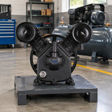 Mirage MY2105VWT cast-iron compressor pump resting beside a compatible compressor rebuild station in a clean fabrication shop