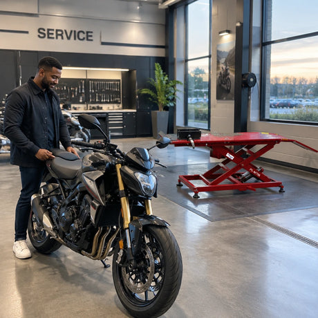 Serviced motorcycle ready for collection beside the inactive Mirage PL-MT06 lift in a clean dealership workshop.
