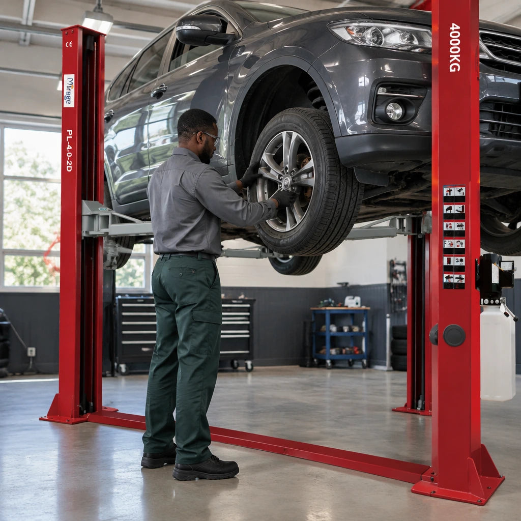 African American automotive technician inspecting a raised passenger vehicle’s wheel on the Mirage PL-4.0-2D lift