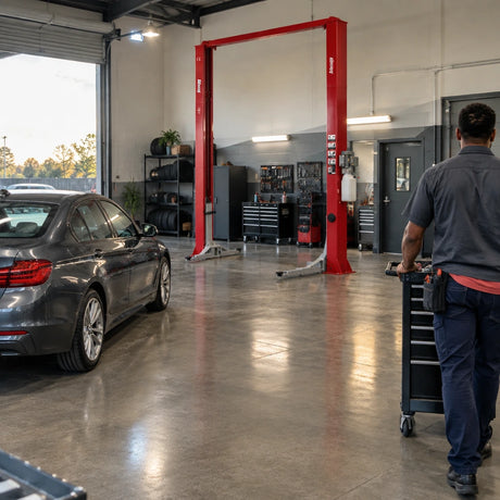 Completed vehicle service bay with a Mirage PL-4.0-2DA lift parked behind a serviced car and open floor for workshop movement
