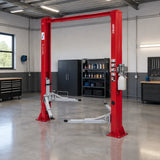 Mirage red two-post vehicle lift installed in a clean professional automotive workshop with open floor space