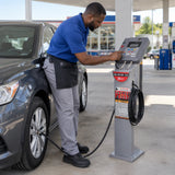 African American fuel-station attendant using the Mirage HJ-931B-LX automatic inflator to adjust a passenger-car tyre.