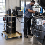 Technician using the Mirage 71031940 oil pump trolley to dispense engine oil into a fleet vehicle