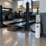 Ready-to-use workshop lifting platform with the Mirage hydraulic power unit resting beside its connected hydraulic system