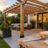 Completed timber pergola in a contemporary courtyard with the Mister handsaw resting nearby