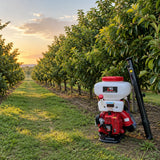 Maintained orchard row with the inactive NRG gasoline knapsack sprayer resting nearby after crop treatment