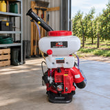 NRG gasoline knapsack sprayer stored upright in a clean orchard equipment shed beside orderly crop rows