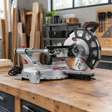 NRG sliding compound mitre saw resting on a timber workbench in an organised cabinetmaking workshop.