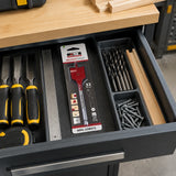 Packaged NRG 32mm flat wood drill bit stored in an organised electrical installation workshop tool drawer.