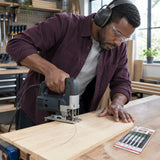 Furniture maker guiding a compatible jigsaw with an NRG T244D blade through a curved line in a supported wood panel
