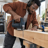 African American carpenter using a compatible jigsaw fitted with an NRG T344D blade to cut a thick supported softwood beam
