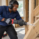 African American carpenter using a compatible reciprocating saw with an NRG 150mm wood blade to cut a supported timber stair component