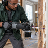 African American renovation carpenter using an NRG 150mm bi-metal reciprocating blade to cut a nailed timber door frame