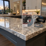 Finished granite countertop edge ready for installation with the NRG diamond disc and compatible angle grinder resting nearby.