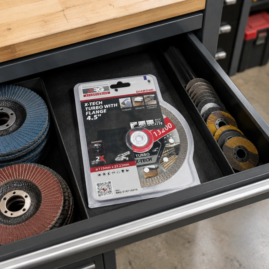 Packaged NRG 115mm diamond cutting disc stored in an organised renovation workshop accessory drawer