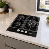 Kaiser black three-burner gas hob installed in a contemporary apartment kitchen peninsula