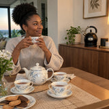 Ready teapot and cups with the black Kaiser Empire electric kettle resting nearby in a contemporary dining room.