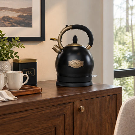 Black Kaiser Empire electric kettle resting on its base at a refined home dining-room beverage station.