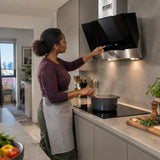 African American home cook adjusts the Kaiser AT 6438 F Eco hood while simmering stew in a contemporary kitchen