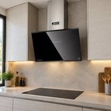 Kaiser AT 6488 Eco black-glass angled cooker hood installed above a hob in a contemporary apartment kitchen.