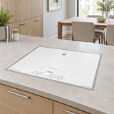 White Kaiser La Perle four-zone induction hob installed flush in a refined contemporary kitchen island.