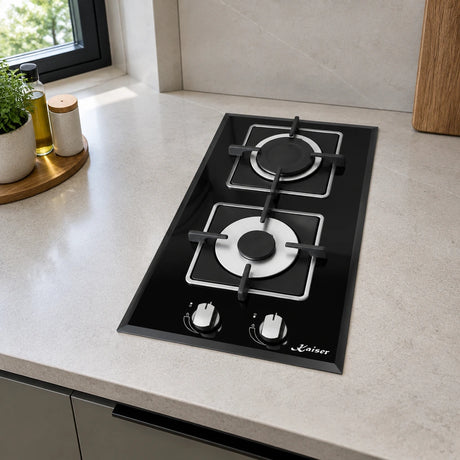 Kaiser two-burner black domino gas hob installed in a compact contemporary apartment kitchenette