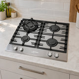 White and black Kaiser four-burner gas hob fitted into a contemporary apartment kitchen worktop.