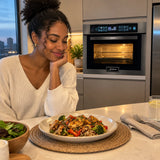 Ready warm meal served beside a closed Kaiser compact microwave oven in a contemporary kitchen