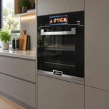 Kaiser EH 6344 black built-in electric oven installed in a contemporary kitchen cabinet wall