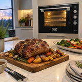 Finished roast and baked vegetables ready to serve with the Kaiser 105L black gas oven visible in the contemporary kitchen.