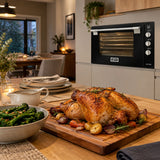 Finished browned roast ready to serve with the Kaiser wide black gas oven visible in the contemporary kitchen.