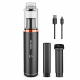 Decakila CMPV004B cordless handheld vacuum with transparent dust chamber, two nozzles, brush attachment and charging cables on white background.