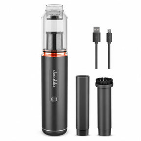 Decakila CMPV004B cordless handheld vacuum with transparent dust chamber, two nozzles, brush attachment and charging cables on white background.